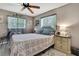 Cozy bedroom with natural lighting from the window, a ceiling fan, and a comfortable bed at 13460 Pia Ct, Spring Hill, FL 34609