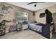 Cozy bedroom with neutral walls, ceiling fan, and a large window offering natural light at 13460 Pia Ct, Spring Hill, FL 34609