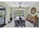 Charming dining room with farmhouse table, stylish lighting and large windows at 13460 Pia Ct, Spring Hill, FL 34609