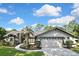 Charming home with a two-car garage, a well-manicured lawn, and professional landscaping enhancing its curb appeal at 13460 Pia Ct, Spring Hill, FL 34609