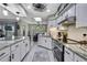 Open kitchen with stone countertops, stainless appliances, and a skylight at 13460 Pia Ct, Spring Hill, FL 34609