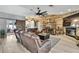 Spacious living room features a stone fireplace, wood accent wall, leather sofas, and stylish decor with lots of seating at 13460 Pia Ct, Spring Hill, FL 34609