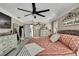 Well-lit main bedroom with a decorative sign above the bed and an open en-suite bathroom at 13460 Pia Ct, Spring Hill, FL 34609