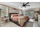 Comfortable main bedroom featuring a slider to the backyard, large ceiling fan, and decorative wall art at 13460 Pia Ct, Spring Hill, FL 34609