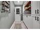 Well-organized pantry with white cabinetry, wooden shelves, and a door to the outside at 13460 Pia Ct, Spring Hill, FL 34609
