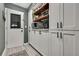 Pantry features white cabinets with black handles, wooden shelves, and a door with a window at 13460 Pia Ct, Spring Hill, FL 34609