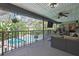 Screened-in patio with outdoor furniture and ceiling fans, overlooking a pool and green landscape at 13460 Pia Ct, Spring Hill, FL 34609