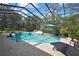 This gorgeous pool has a screened-in enclosure and plenty of lounge seating at 13460 Pia Ct, Spring Hill, FL 34609