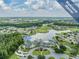 Inviting aerial view of a neighborhood clubhouse featuring a pool, golf course, and community amenities at 1407 Hickory Moss Pl, Trinity, FL 34655