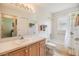 Well-lit bathroom featuring a single sink vanity and a shower-tub combo with neutral color tones at 1407 Hickory Moss Pl, Trinity, FL 34655