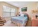 Charming bedroom with a bed, rocking chair, and window, offering a peaceful and inviting space at 1407 Hickory Moss Pl, Trinity, FL 34655