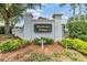 Entrance sign for Clubhouse Village with mature landscaping adding to the community's charm at 1407 Hickory Moss Pl, Trinity, FL 34655