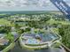 Beautiful aerial view of a community clubhouse with a pool, golf course, and picturesque surroundings at 1407 Hickory Moss Pl, Trinity, FL 34655