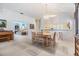 Bright dining space with chandelier, wood table and seating for six, seamlessly connected to kitchen and living areas at 1407 Hickory Moss Pl, Trinity, FL 34655