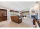 Spacious living area with neutral carpet, a fireplace, and access to the outdoor lanai at 1407 Hickory Moss Pl, Trinity, FL 34655