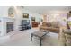 Cozy living room with fireplace, comfortable seating, neutral carpet, and vaulted ceiling at 1407 Hickory Moss Pl, Trinity, FL 34655