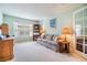 Comfortable living area features a bright window, sofa, bookcase, and light-colored walls, creating a serene ambiance at 1407 Hickory Moss Pl, Trinity, FL 34655