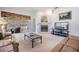 Living room with glass doors to a screened patio, fireplace, and neutral carpet at 1407 Hickory Moss Pl, Trinity, FL 34655