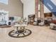 Open concept lobby featuring a brick fireplace, comfortable seating, and tile floors at 1407 Hickory Moss Pl, Trinity, FL 34655