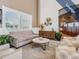 Cozy lounge area with comfortable seating, decorative accents, and natural light at 1407 Hickory Moss Pl, Trinity, FL 34655