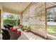 Enclosed patio with lattice privacy and wicker furniture offers a serene relaxation space with plants at 1407 Hickory Moss Pl, Trinity, FL 34655