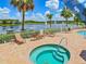 Relaxing spa area with jacuzzi and lounge chairs overlooking the lake at 1407 Hickory Moss Pl, Trinity, FL 34655