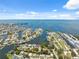 Expansive aerial view showcasing a coastal community with canals, boat slips, and waterfront properties on a sunny day at 14220 Hendry Ct, Hudson, FL 34667