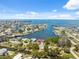 Scenic aerial view of waterfront homes, boat docks, and a marina under a sunny, partly cloudy sky at 14220 Hendry Ct, Hudson, FL 34667