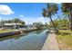 Backyard view of canal with seawall, showcasing the property's access to waterways at 14220 Hendry Ct, Hudson, FL 34667