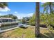 Backyard view of canal with boat parked on land, showcasing the property's access to waterways at 14220 Hendry Ct, Hudson, FL 34667
