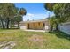 Backyard view of the single-story home at 14220 Hendry Ct, Hudson, FL 34667