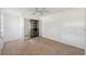 An empty bedroom features wood paneling and neutral tile flooring at 14220 Hendry Ct, Hudson, FL 34667
