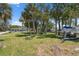 Exterior view of waterfront property with palm trees and a boat at 14220 Hendry Ct, Hudson, FL 34667