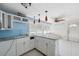 A kitchen with granite counters and white cabinetry needs repairs at 14220 Hendry Ct, Hudson, FL 34667