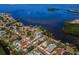 Scenic aerial view of waterfront homes on a clear blue canal and bay at 1620 Sea Breeze Dr, Tarpon Springs, FL 34689