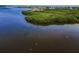Stunning aerial view of an island neighborhood surrounded by beautiful blue water and lush greenery at 1620 Sea Breeze Dr, Tarpon Springs, FL 34689