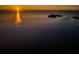 Serene aerial view of sunset over the water featuring a tranquil sky and islands at 1620 Sea Breeze Dr, Tarpon Springs, FL 34689