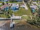 Aerial view of the waterfront property featuring a spacious yard and private dock at 1620 Sea Breeze Dr, Tarpon Springs, FL 34689