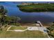 Private beach with dock on a waterfront property, ideal for relaxation and entertainment at 1620 Sea Breeze Dr, Tarpon Springs, FL 34689