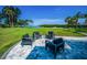 Backyard patio offers a cozy conversation area with comfortable seating and a beautiful water view at 1620 Sea Breeze Dr, Tarpon Springs, FL 34689