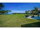 Spacious backyard offers a lush lawn, patio seating, and stunning water views at 1620 Sea Breeze Dr, Tarpon Springs, FL 34689