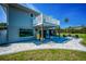 Back of the house features a patio with a beautiful water view and comfortable seating at 1620 Sea Breeze Dr, Tarpon Springs, FL 34689