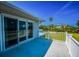 Enjoy the fresh air on this balcony, which features sliding glass doors and views of the fenced backyard at 1620 Sea Breeze Dr, Tarpon Springs, FL 34689