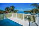 Balcony view of a waterfront property and a dock, surrounded by palm trees at 1620 Sea Breeze Dr, Tarpon Springs, FL 34689