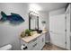 Charming half bathroom with gray walls, fish decor, and unique vessel sink at 1620 Sea Breeze Dr, Tarpon Springs, FL 34689