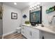 Coastal half bath featuring a unique blue vessel sink and decorative mermaid accents at 1620 Sea Breeze Dr, Tarpon Springs, FL 34689