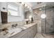 This spacious bathroom features a double sink with marble countertops and a glass-enclosed shower at 1620 Sea Breeze Dr, Tarpon Springs, FL 34689