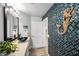 Stylish half bath with blue mosaic wall, vessel sink, and modern fixtures at 1620 Sea Breeze Dr, Tarpon Springs, FL 34689