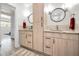 Bright bathroom with double vanities, modern fixtures, and wood-look cabinets at 1620 Sea Breeze Dr, Tarpon Springs, FL 34689