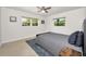 Cozy bedroom with neutral walls, a ceiling fan, and a striped rug at 1620 Sea Breeze Dr, Tarpon Springs, FL 34689